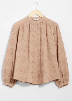 Voluminöse Bluse mit Blumenapplikation